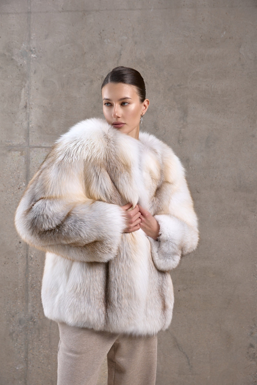 A woman styles an eye-catching full-length gold fox fur coat, crafted from premium fur with a plush, insulating structure and a refined winter silhouette.