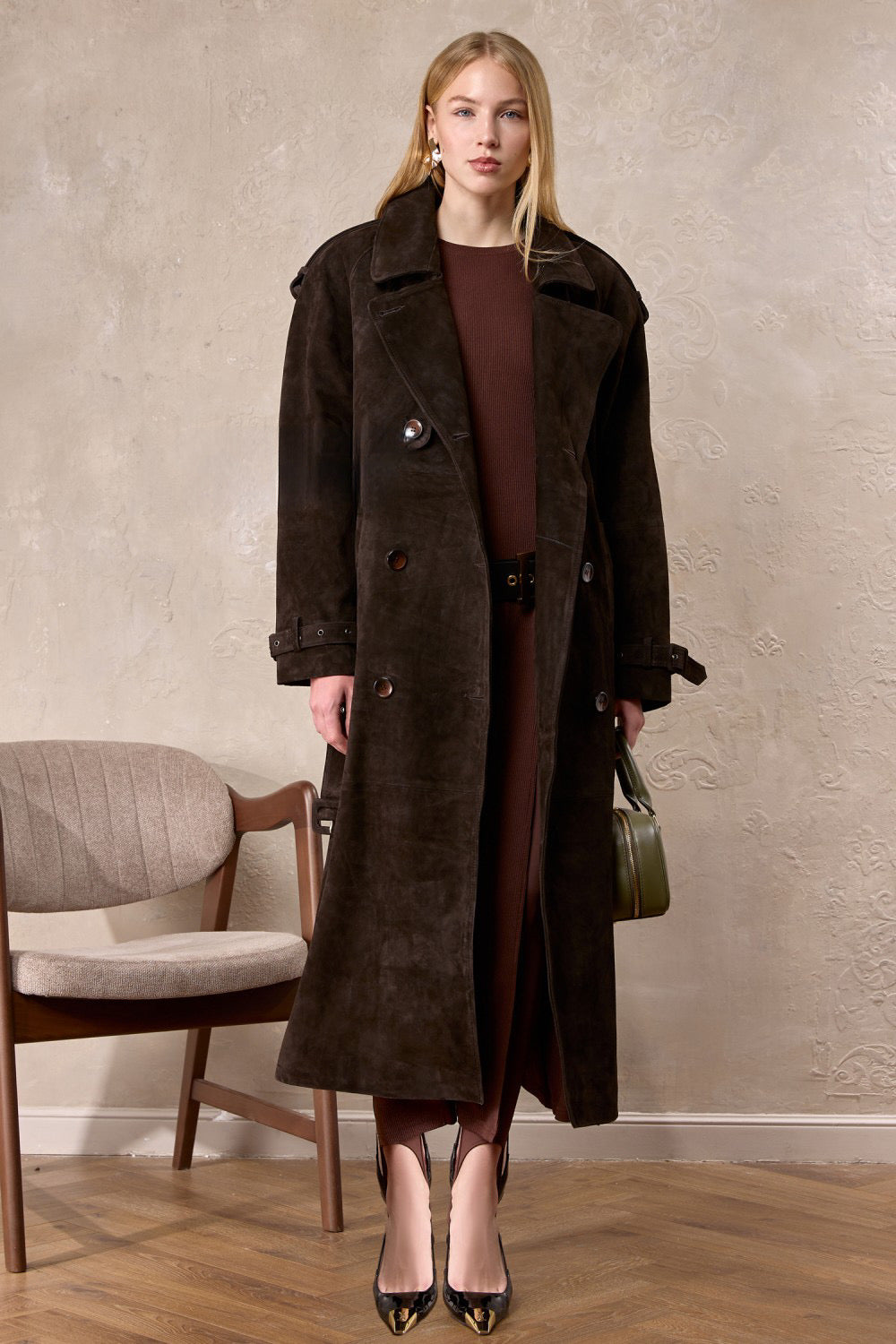 Stylish woman wears the double-breasted Hatti suede leather trench coat, layered comfortably for a chic and polished look.