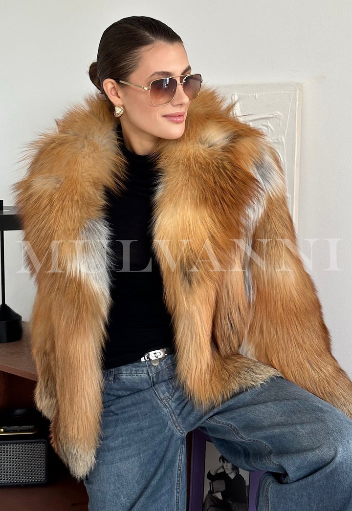 Stylish woman models a warm red fox fur coat, crafted from genuine fur with a bold blend of fiery tones, designed for protection against arctic temperatures.