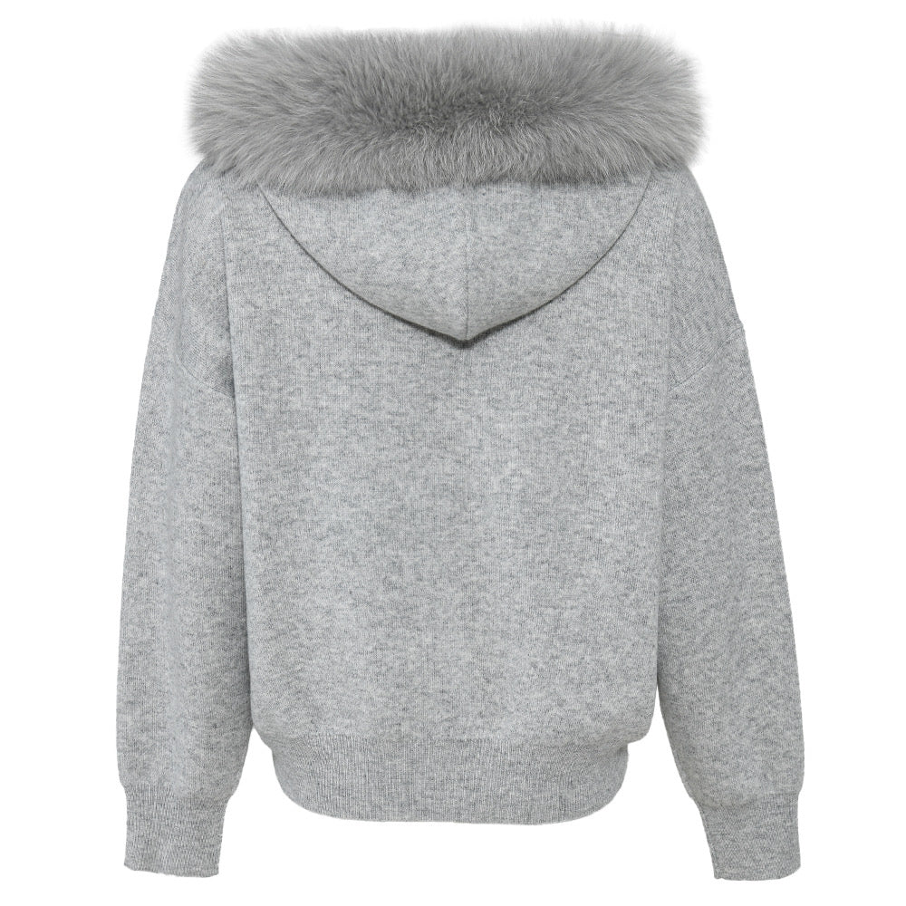 A chic cashmere wool set with a cozy sweater accented by a plush fox fur trim, paired with matching trousers. This stylish ensemble offers both warmth and sophistication for a polished winter look.