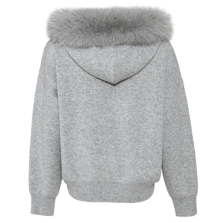 A chic cashmere wool set with a cozy sweater accented by a plush fox fur trim, paired with matching trousers. This stylish ensemble offers both warmth and sophistication for a polished winter look.