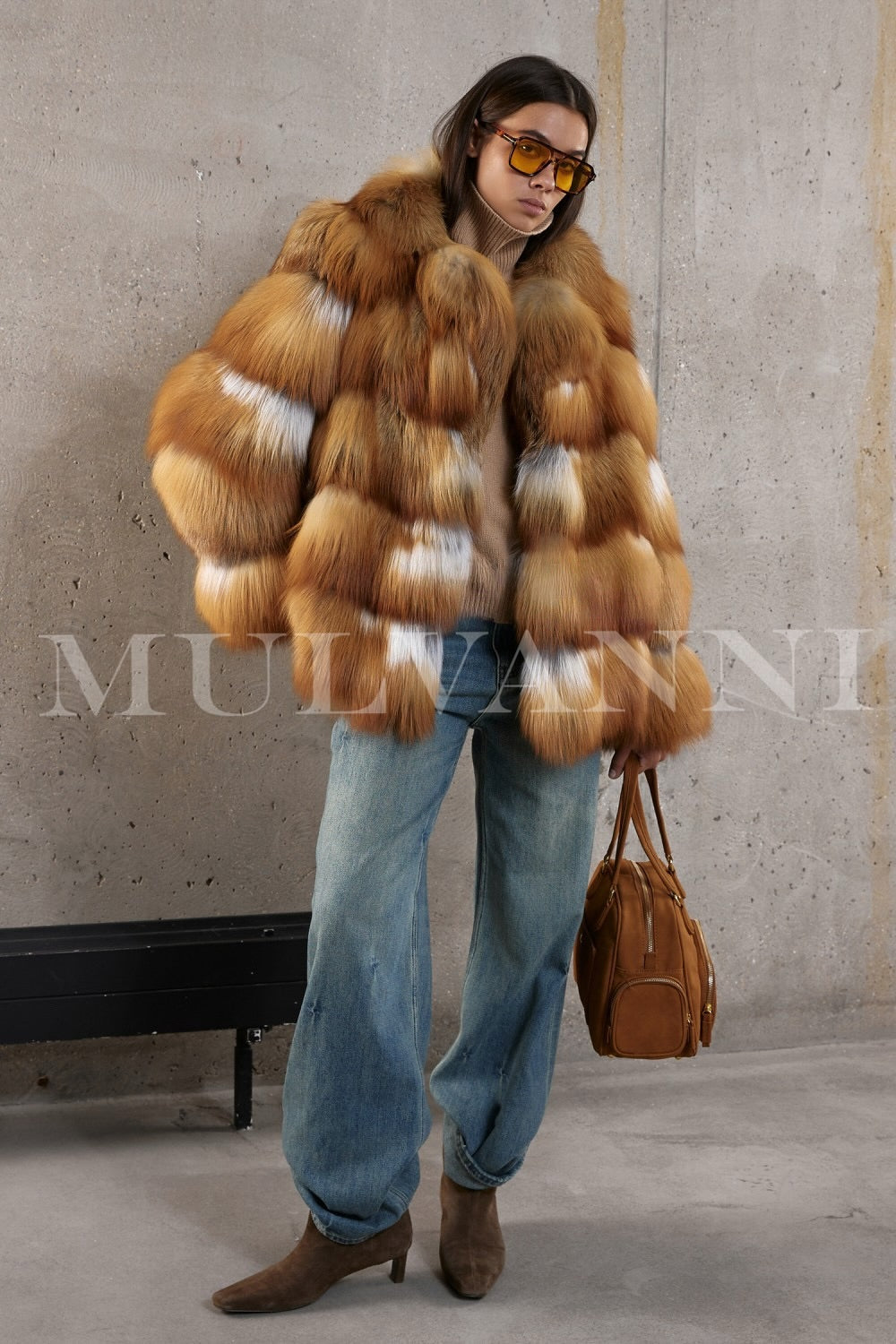 Sophisticated winter outfit featuring a plush red fox fur coat worn with jeans, exuding effortless elegance and warmth.