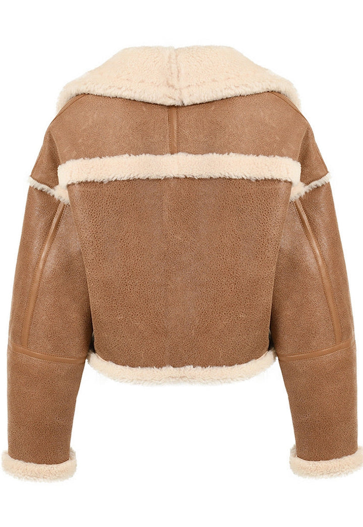 The cropped brown shearling leather jacket blends warmth and modern design, ideal for cool weather outings.