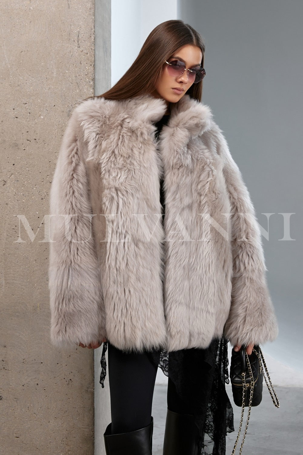 Model styled in a luxurious shearling coat with natural texture and cozy volume, perfect for an elegant cold-weather look.