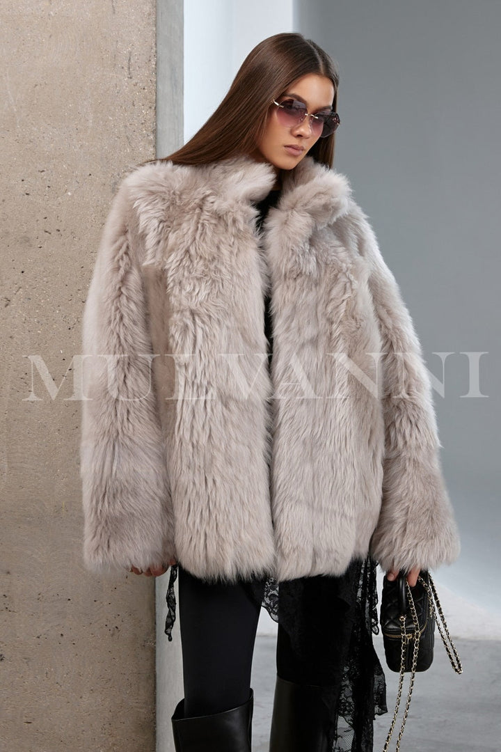 Model styled in a luxurious shearling coat with natural texture and cozy volume, perfect for an elegant cold-weather look.