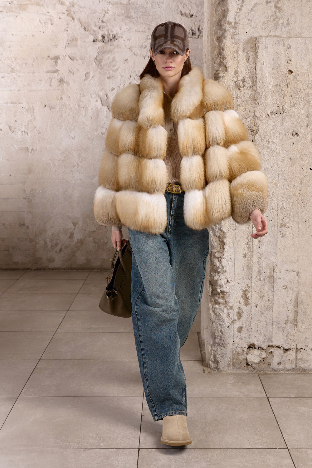 Dressed in jeans and an opulent Gold Fox Fur Coat, a woman exudes winter glamour while staying warm in arctic-ready outerwear.