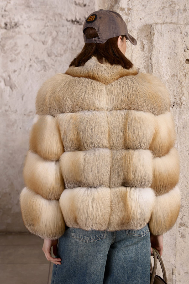 Wearing jeans and a full Gold Fox Fur Coat, a woman effortlessly blends everyday comfort with bold, high-fashion winter luxury.