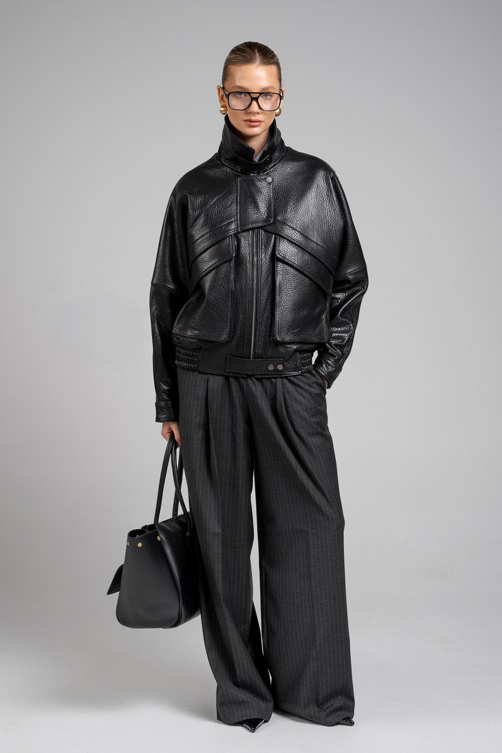 Chic cropped jacket in black genuine leather, perfect for elevated street style and winter layering.