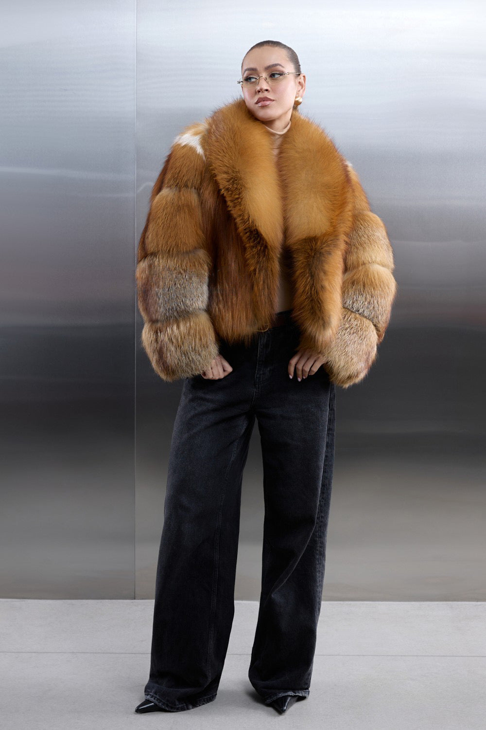 Stylish woman dressed in a voluminous red fox fur coat, showcasing the rich natural tones and softness of the genuine fur.
