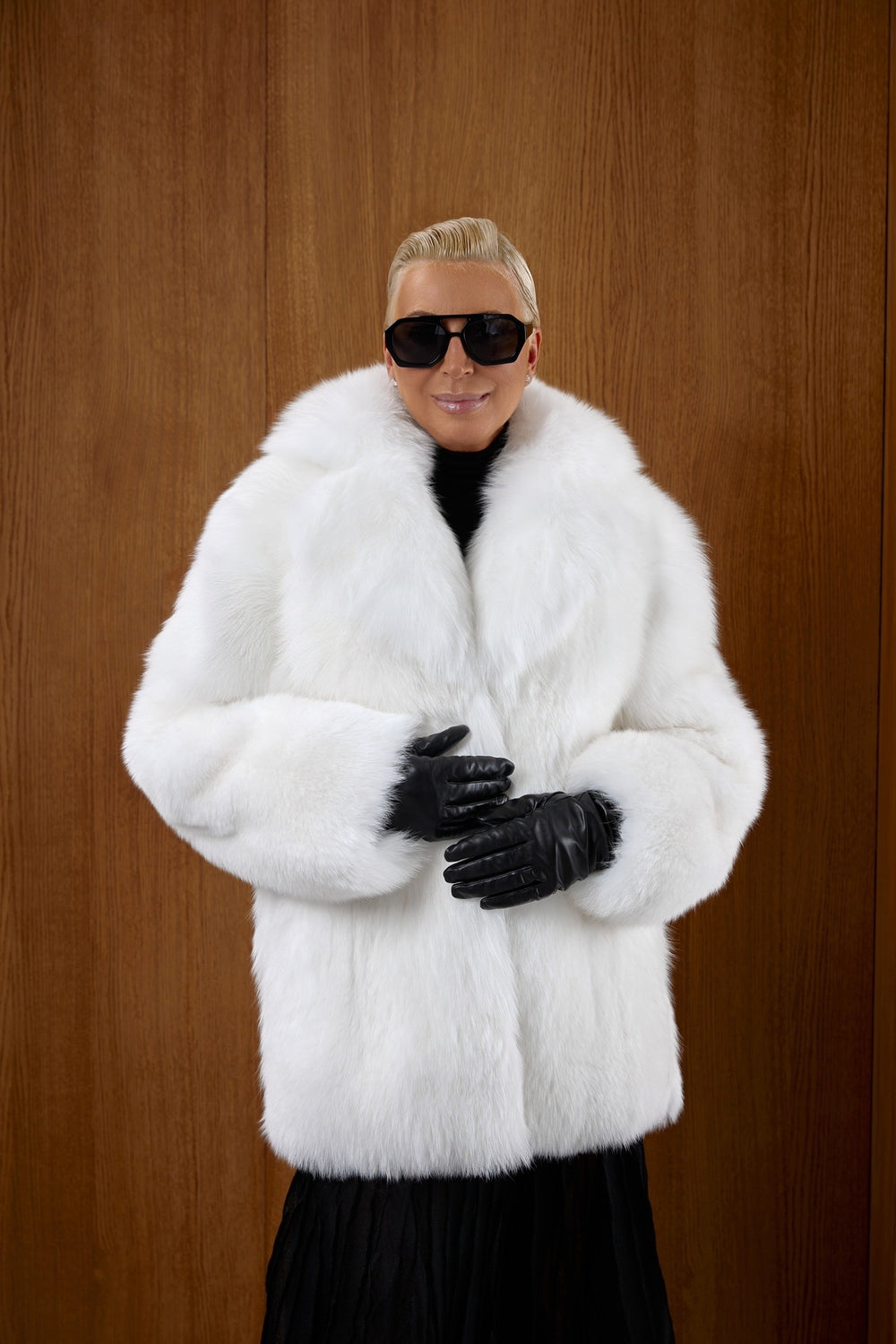 A woman models a striking white fox fur midi coat, crafted from full-piece genuine fur for unmatched warmth, softness, and Arctic-level protection.