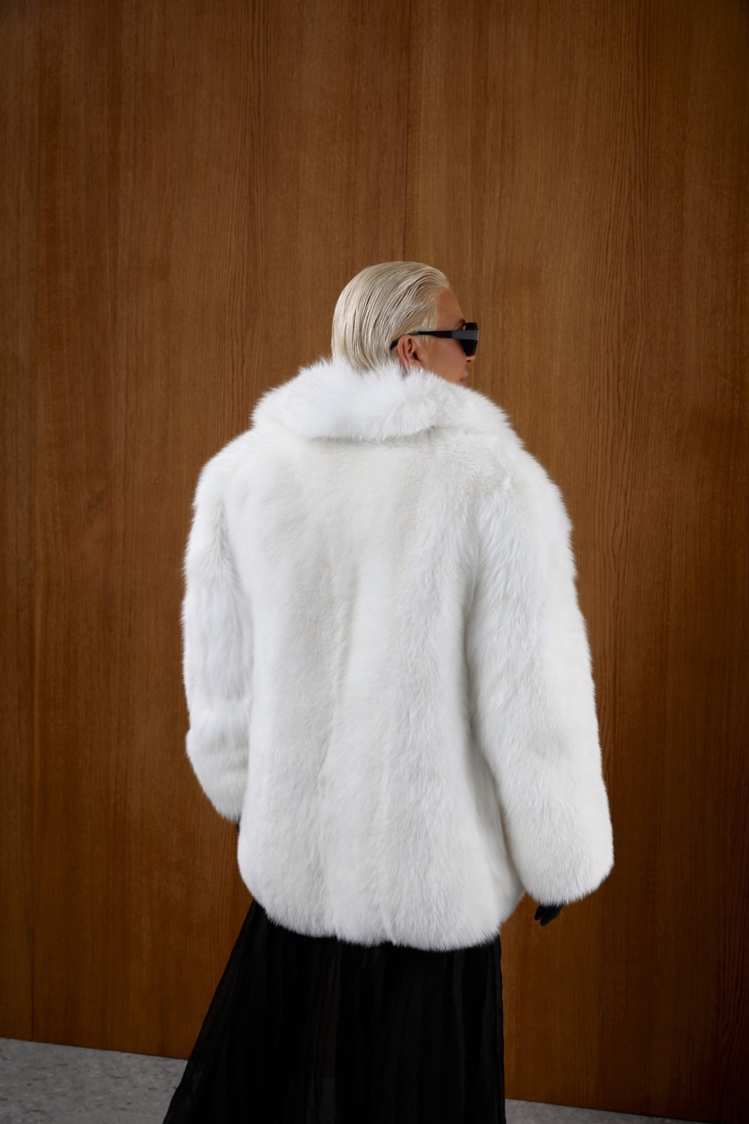 A woman models an opulent white genuine fox fur coat, offering voluminous comfort, a refined neckline, and insulation fit for harsh Arctic climates.