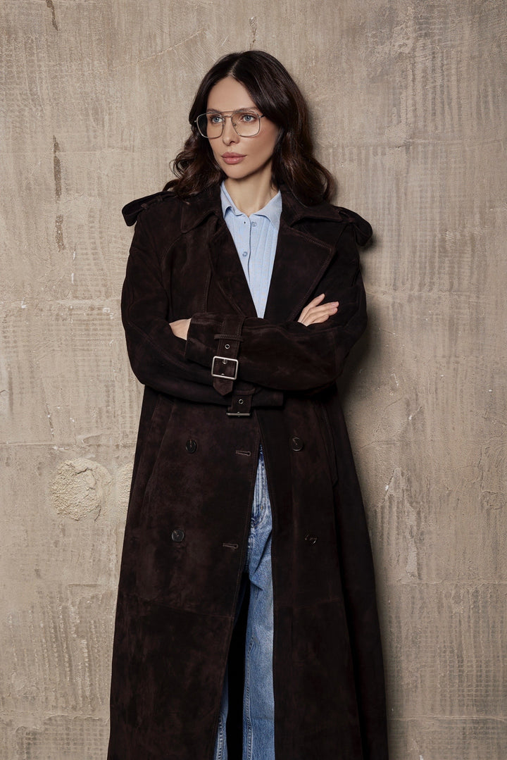 A woman models a modern suede trench coat with structured shoulders and a fitted waist, made from luxurious high-grade suede.