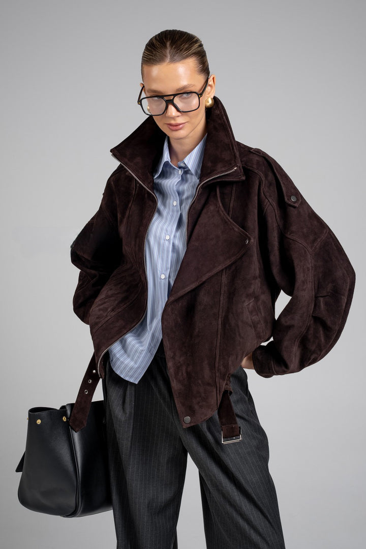 A woman is seen wearing a sporty yet sophisticated suede jacket with a high neck, perfect for elevating casual looks with a touch of luxury.