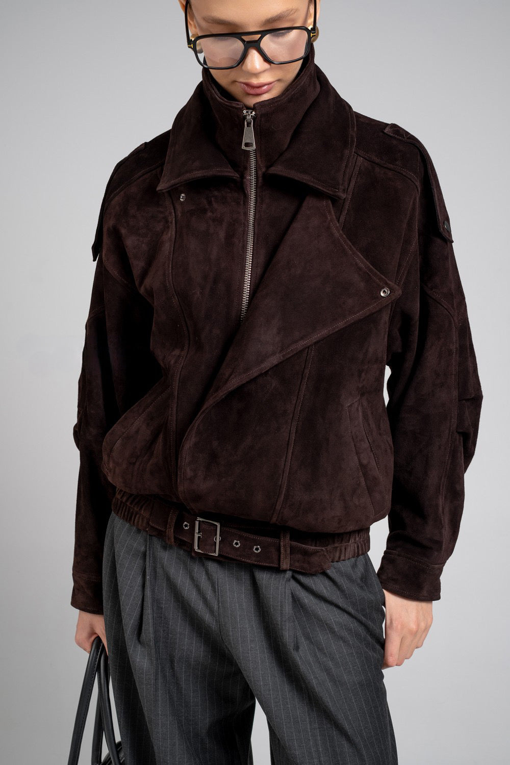 Close up from a sporty yet sophisticated suede jacket with a high neck, perfect for elevating casual looks with a touch of luxury.