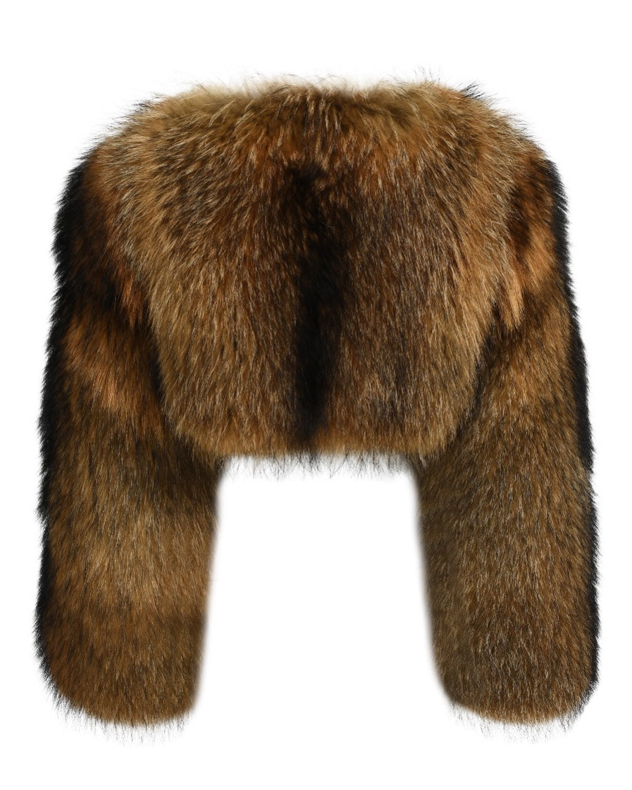 A fashionable cropped raccoon fur coat featuring long sleeves. The rich, multi-toned fur creates a striking contrast, adding flair and sophistication to the woman’s winter attire.