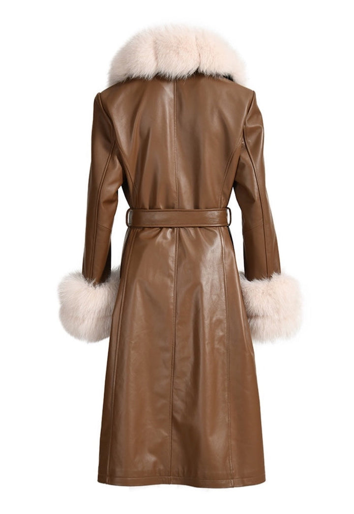  A chic brown leather trench coat featuring a plush beige fox fur collar and cuffs. The combination of leather and fur adds elegance and warmth to her cold-weather attire.