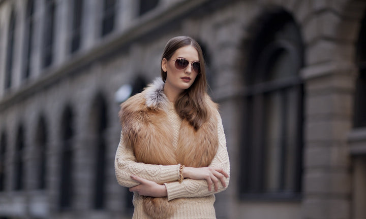 A woman wearing a golden fox fur collar. 